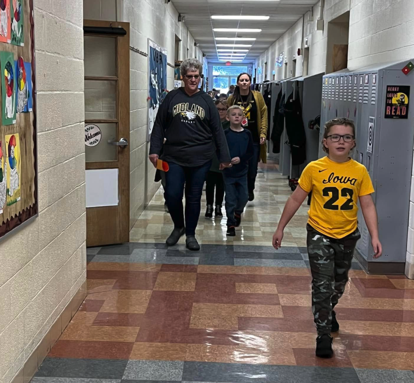 Student walking through halls, leading group