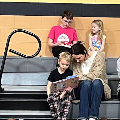 Student reading with parent