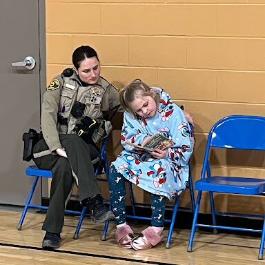 student reading to officer